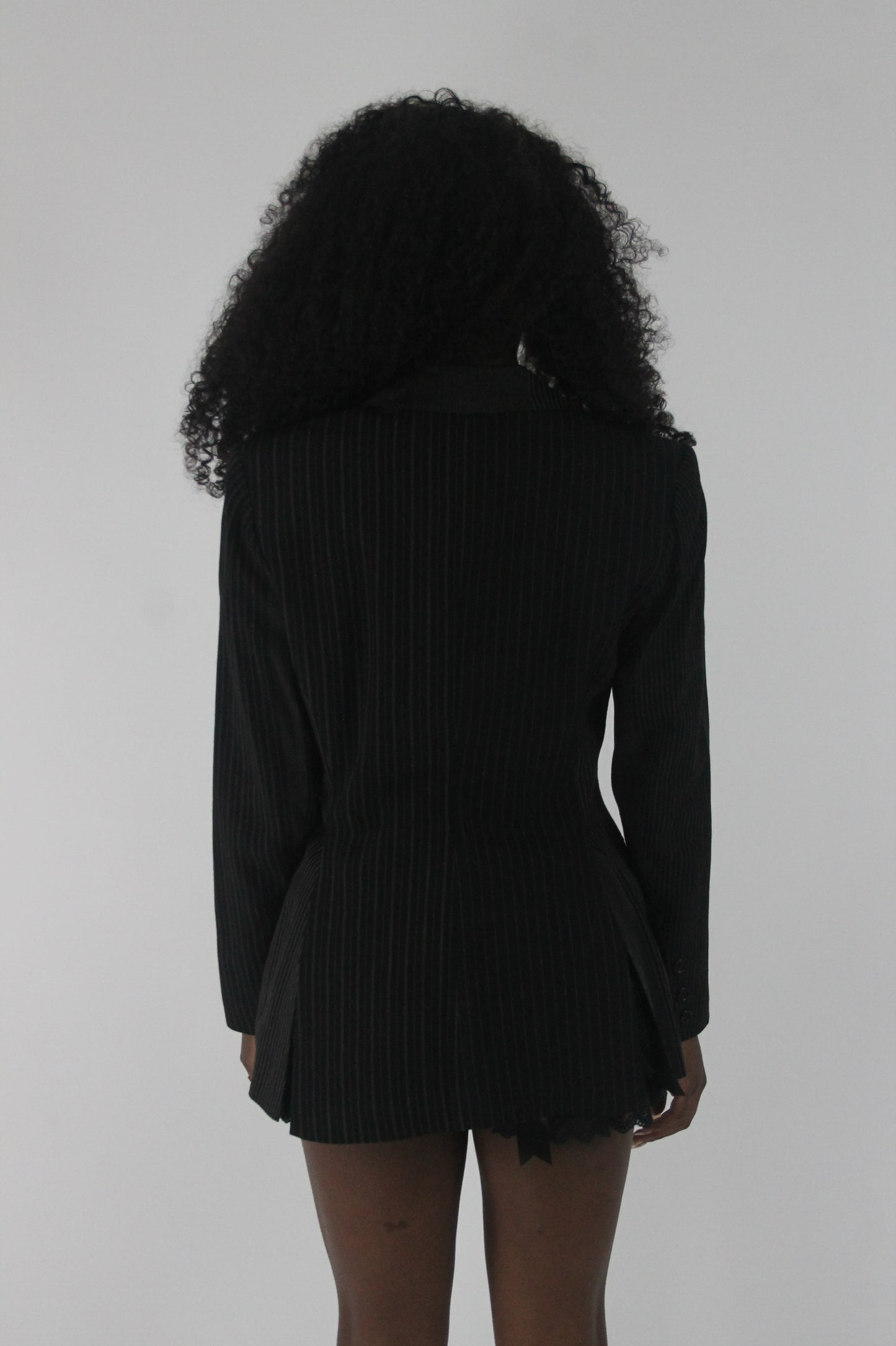 back view of black pinstripe single-button blazer