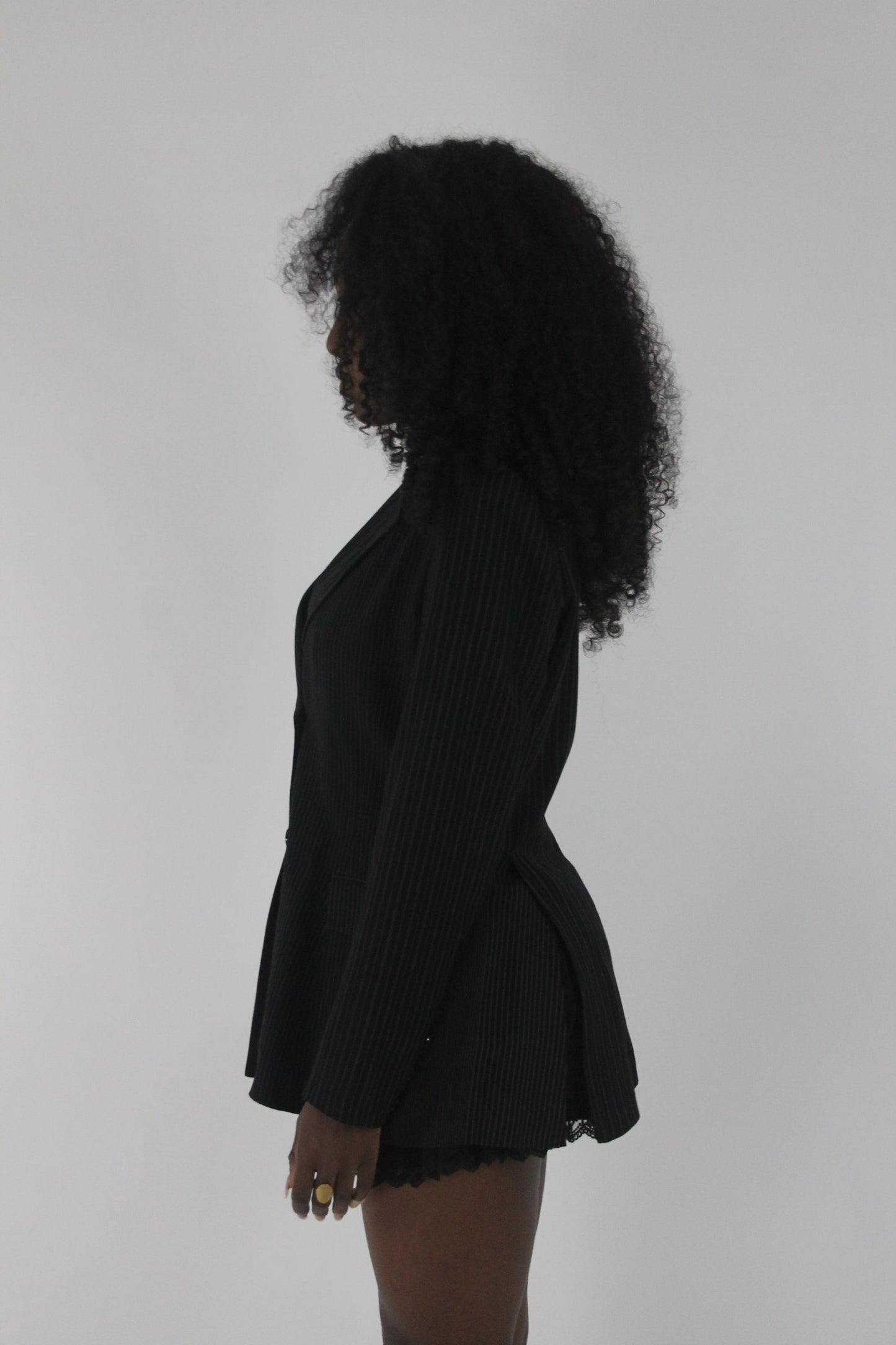 side view of black pinstripe single-button blazer
