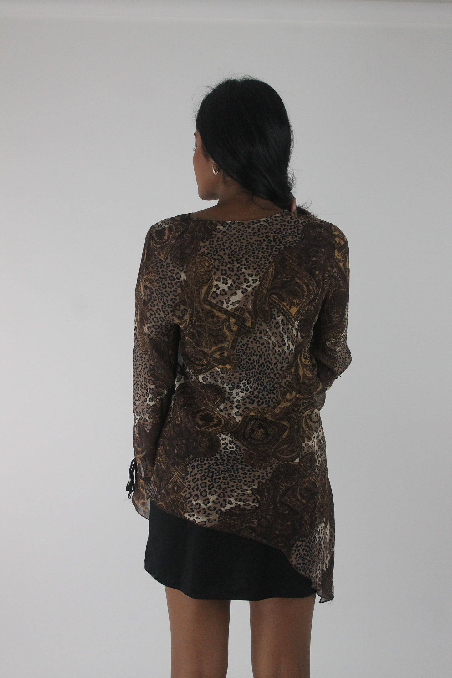 back view of brown paisley-print sheer asymmetric tunic top