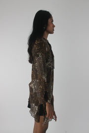 side view of brown paisley-print sheer asymmetric tunic top