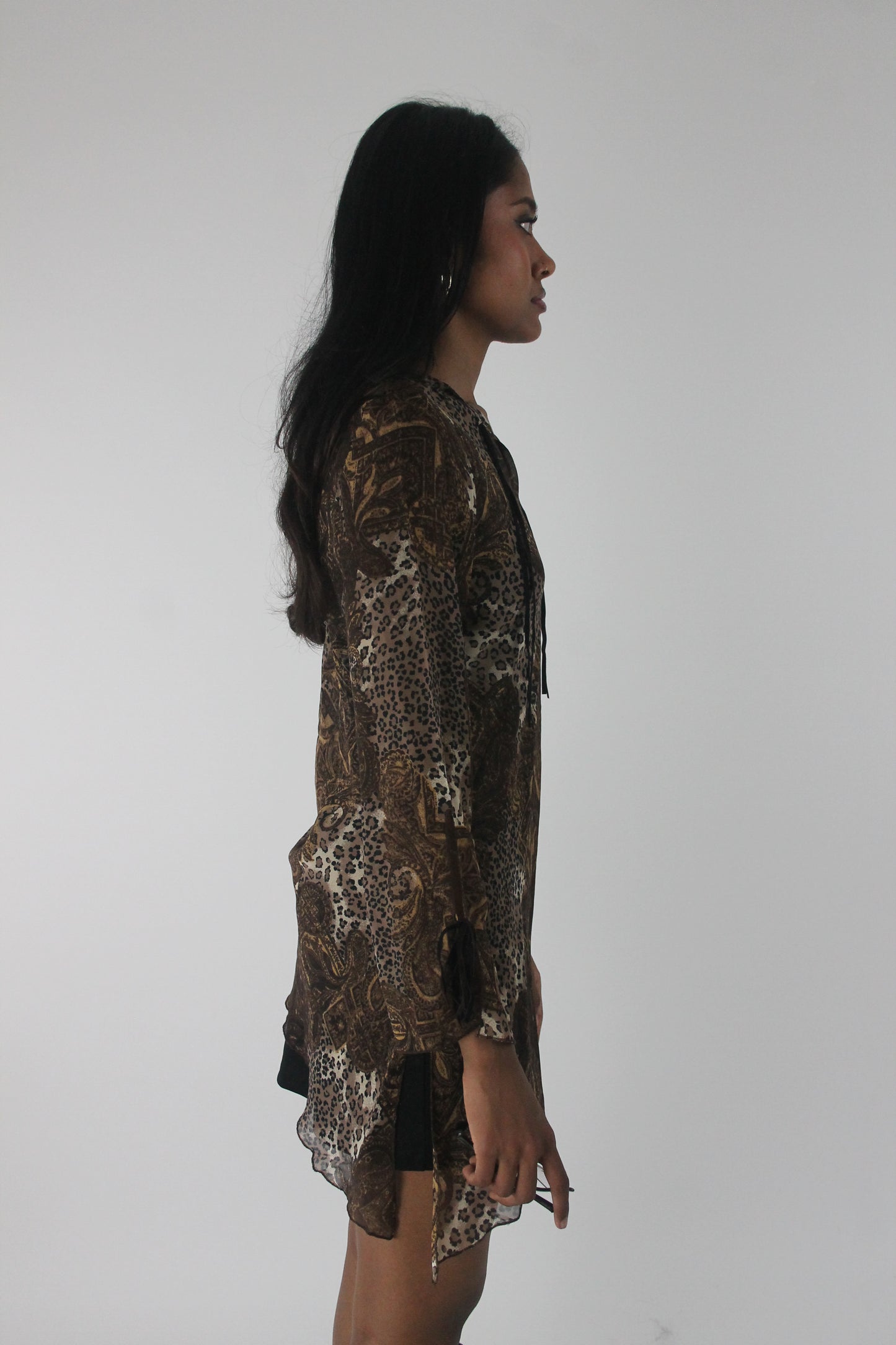 side view of brown paisley-print sheer asymmetric tunic top