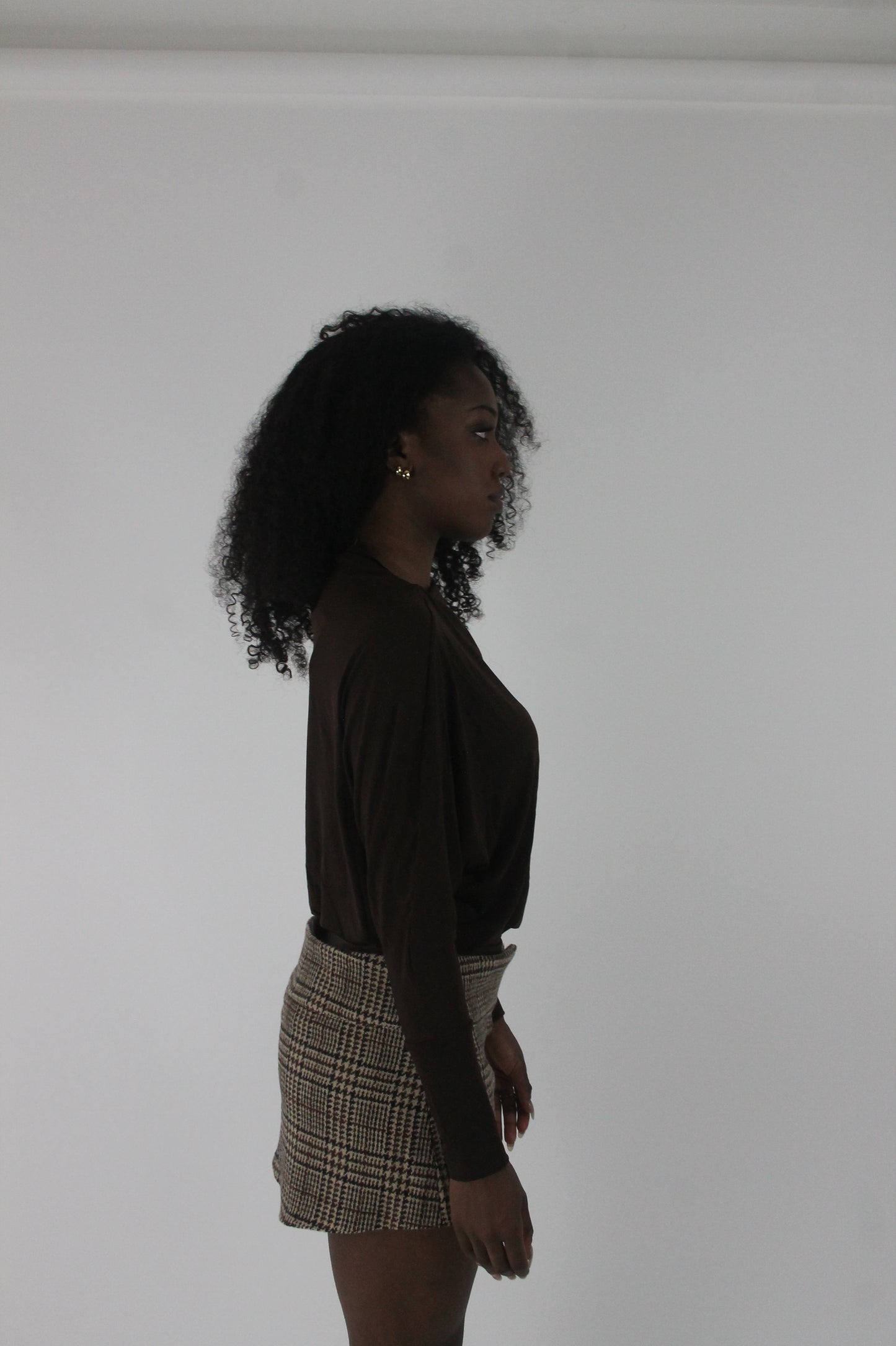 alternate-side view of dark brown boat-neck long-sleeve top