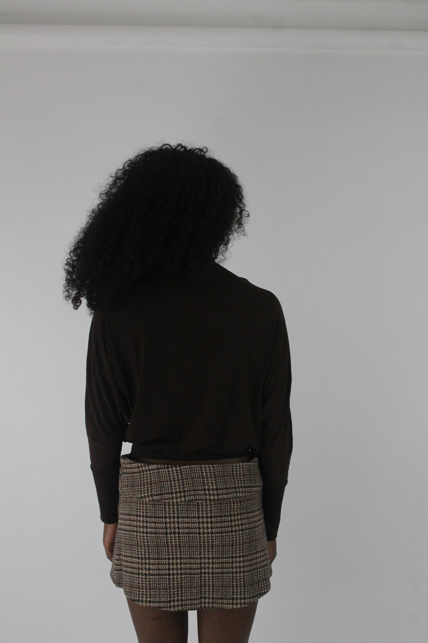 back view of dark brown boat-neck long-sleeve top