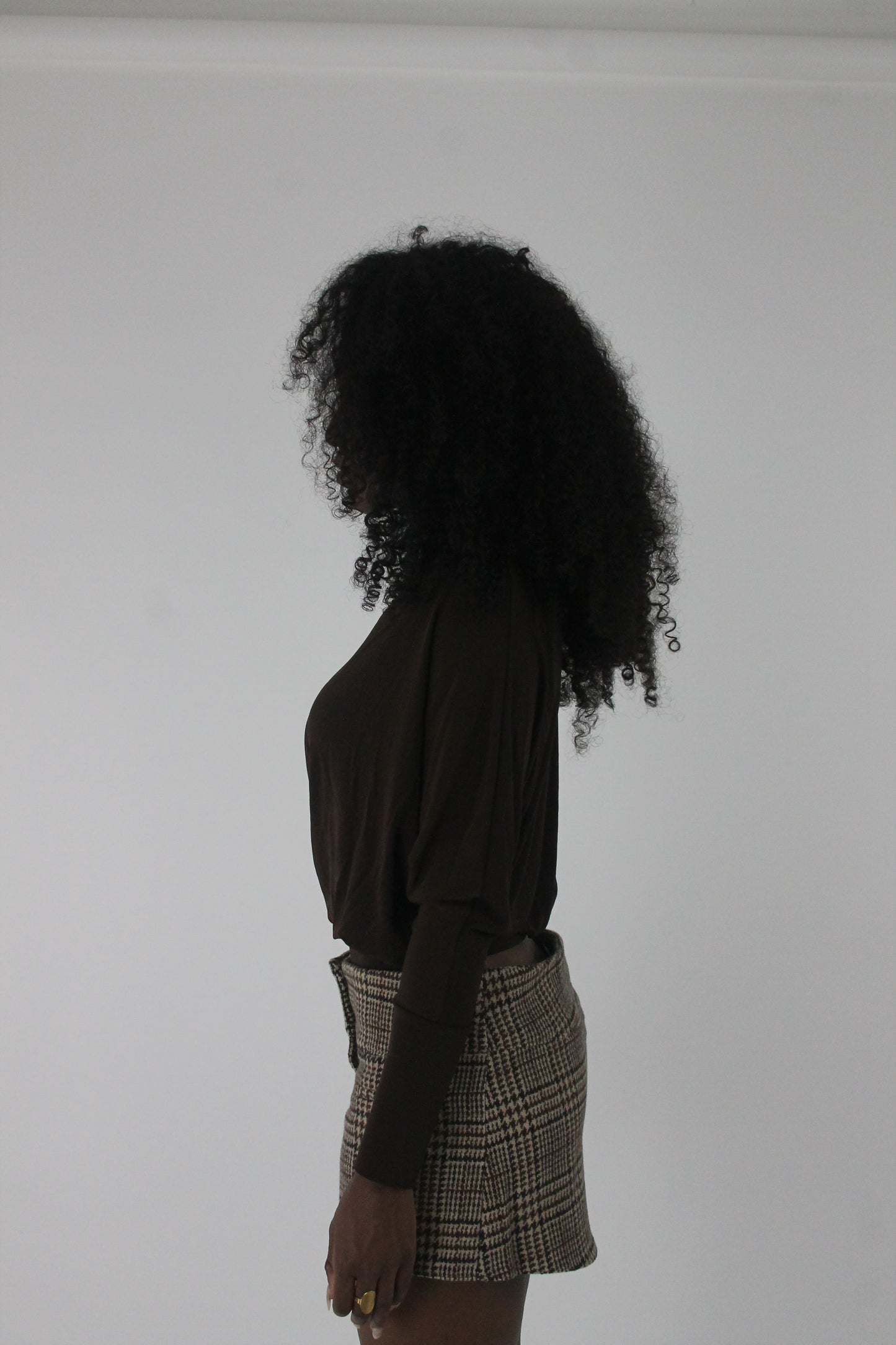 side view of dark brown boat-neck long-sleeve top