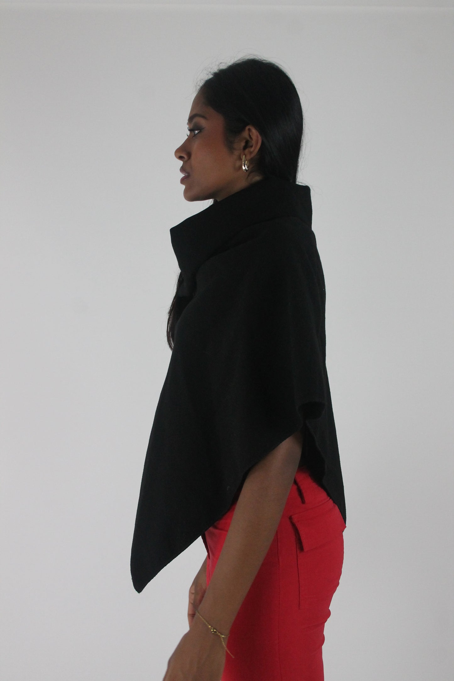 alternate-side view of black button-detail asymmetric poncho