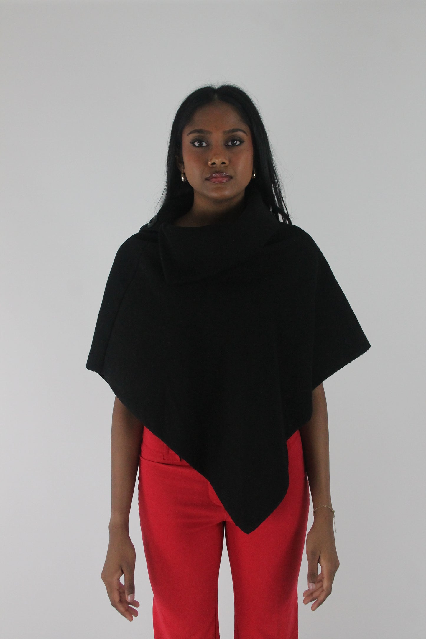 front view of black button-detail asymmetric poncho