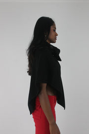 side view of black button-detail asymmetric poncho