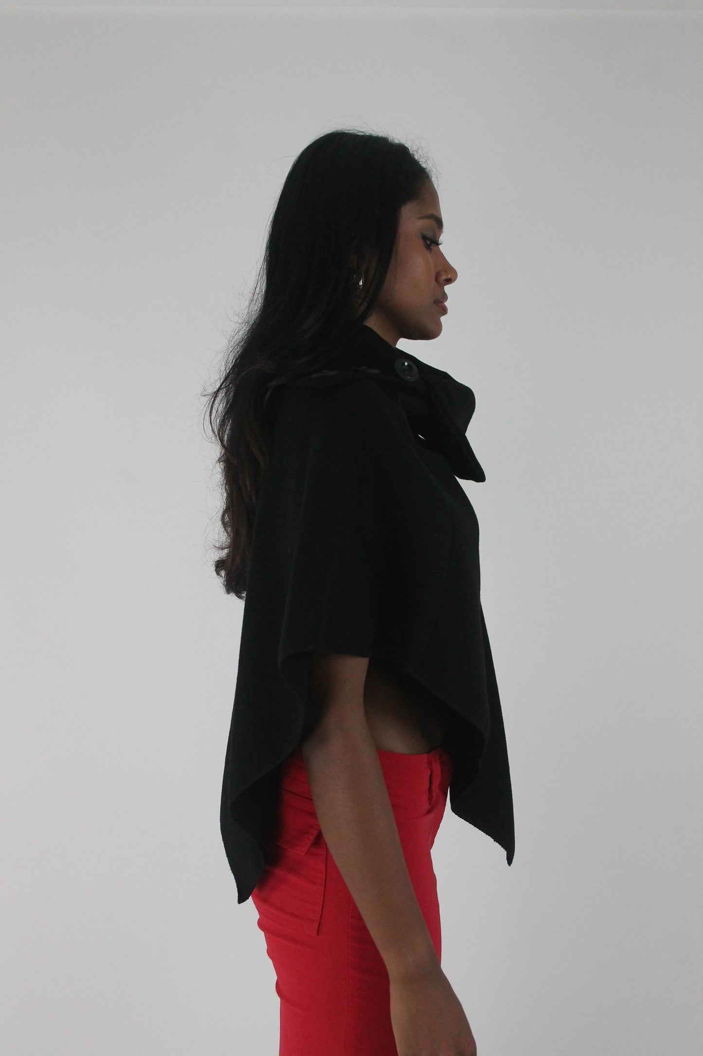 side view of black button-detail asymmetric poncho