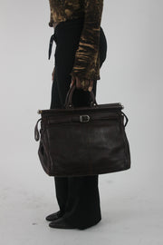 worn view of dark brown structured handbag