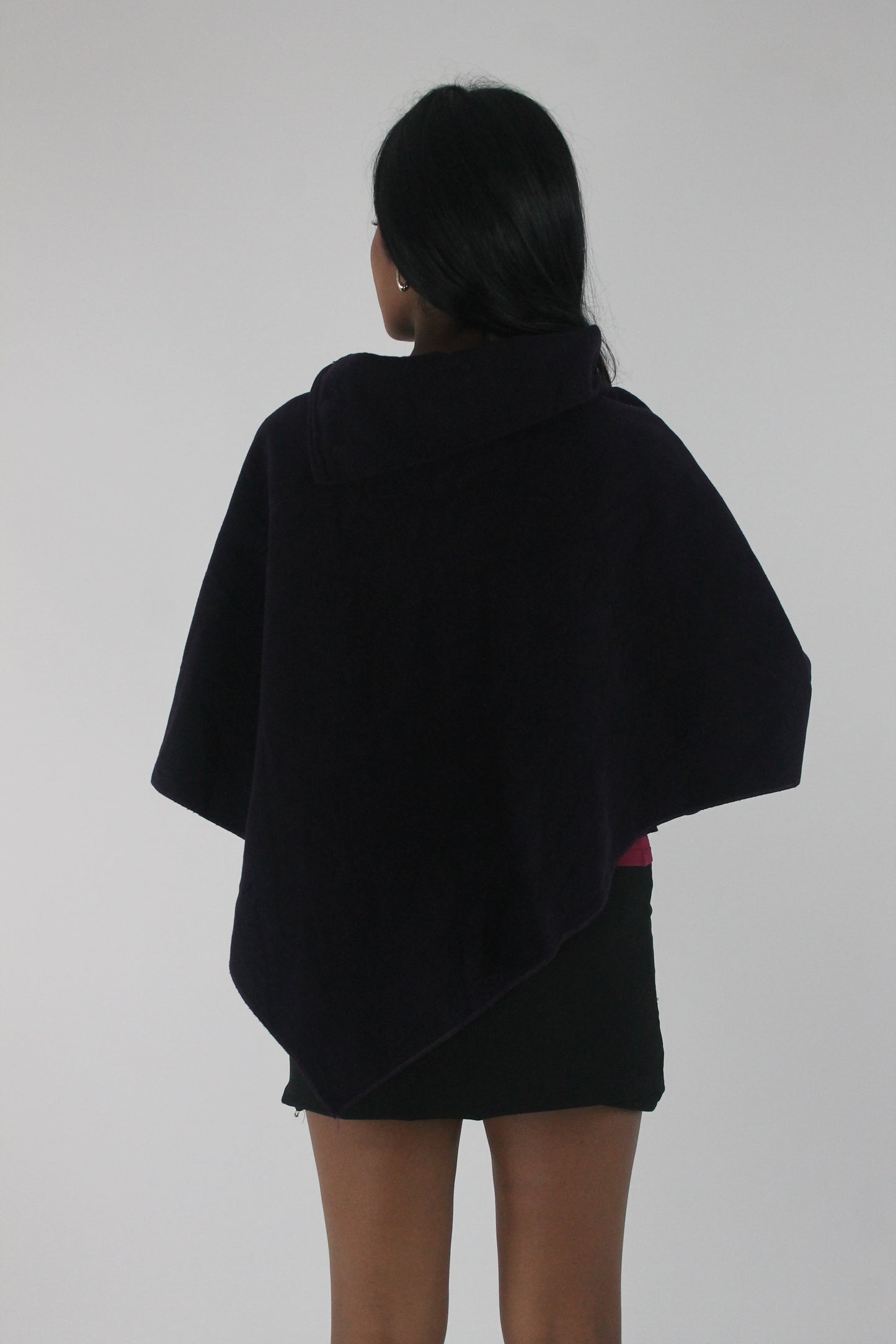 back view of dark purple button-detail asymmetric poncho