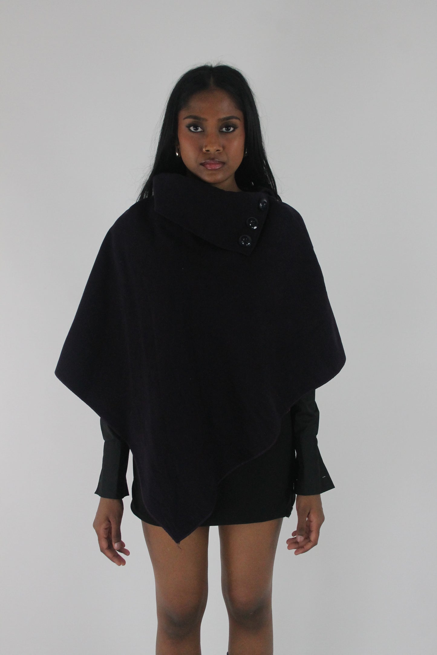 front view of dark purple button-detail asymmetric poncho