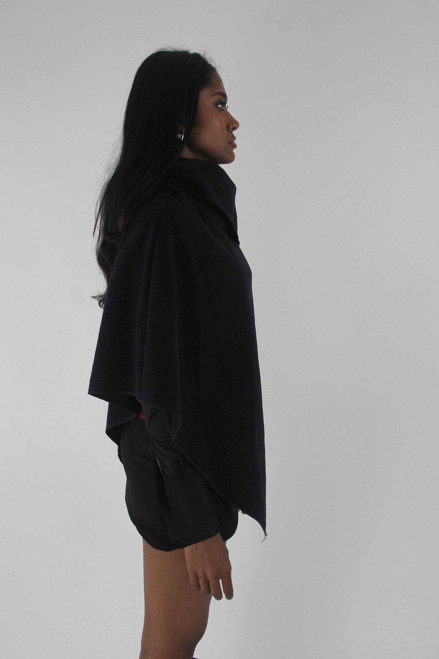 side view of dark purple button-detail asymmetric poncho