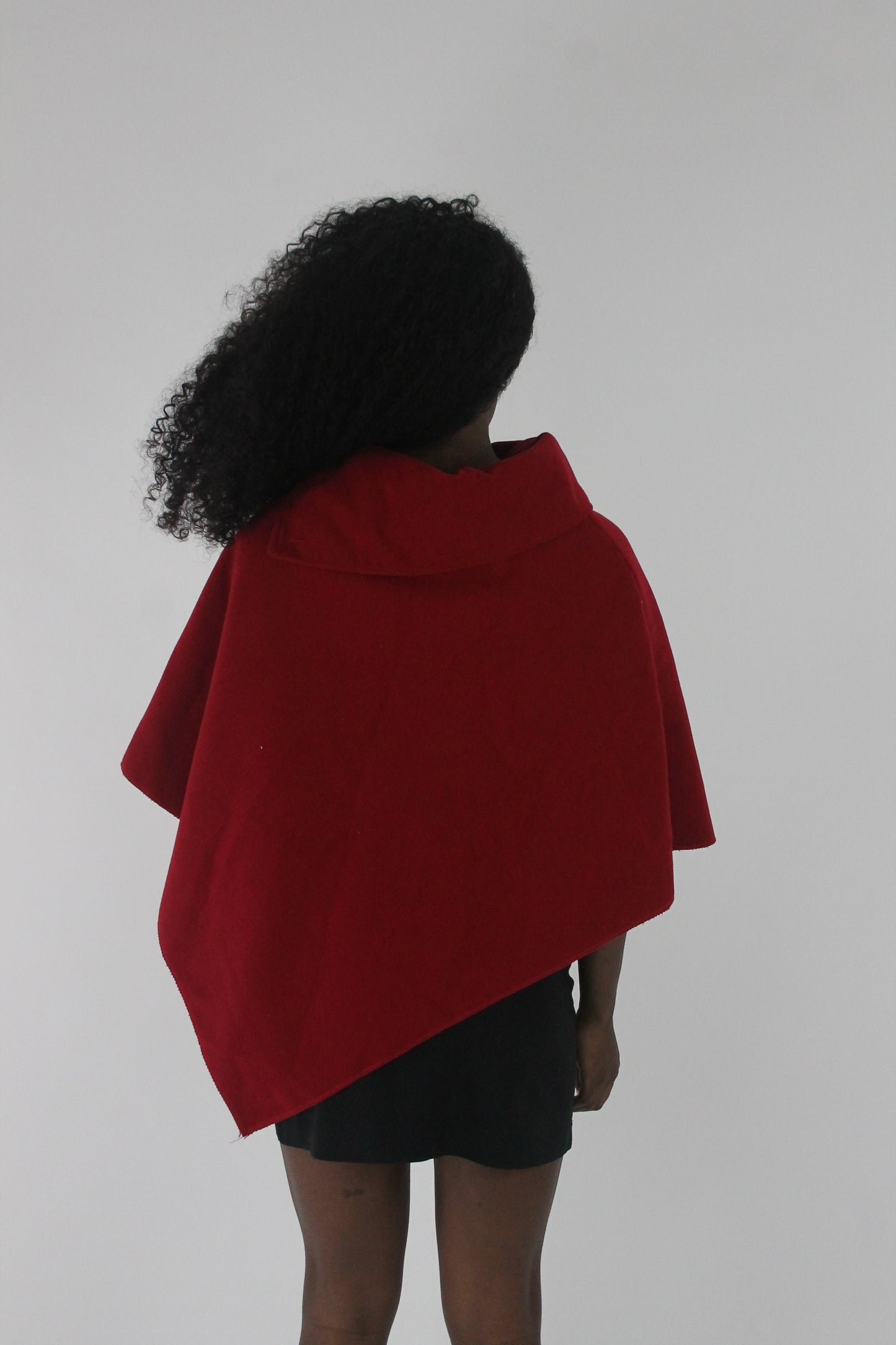 back view of red button-detail asymmetric poncho
