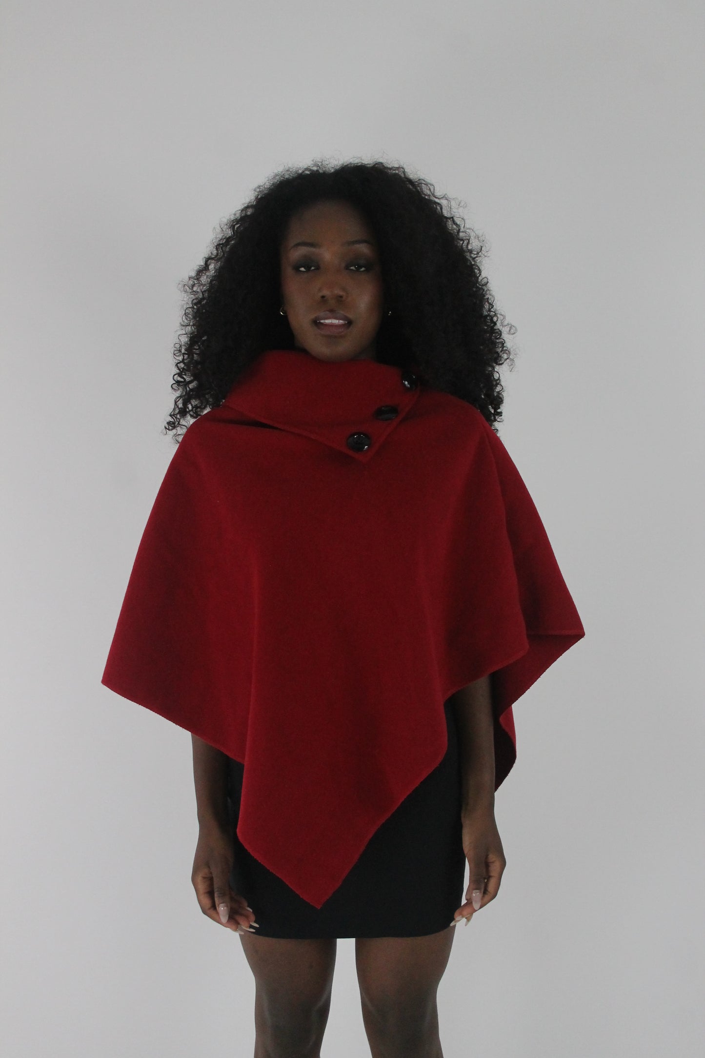 front view of red button-detail asymmetric poncho