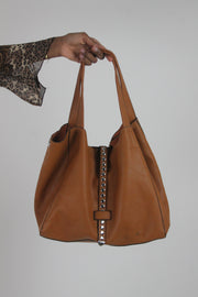 front view of tan studded large shoulder bag