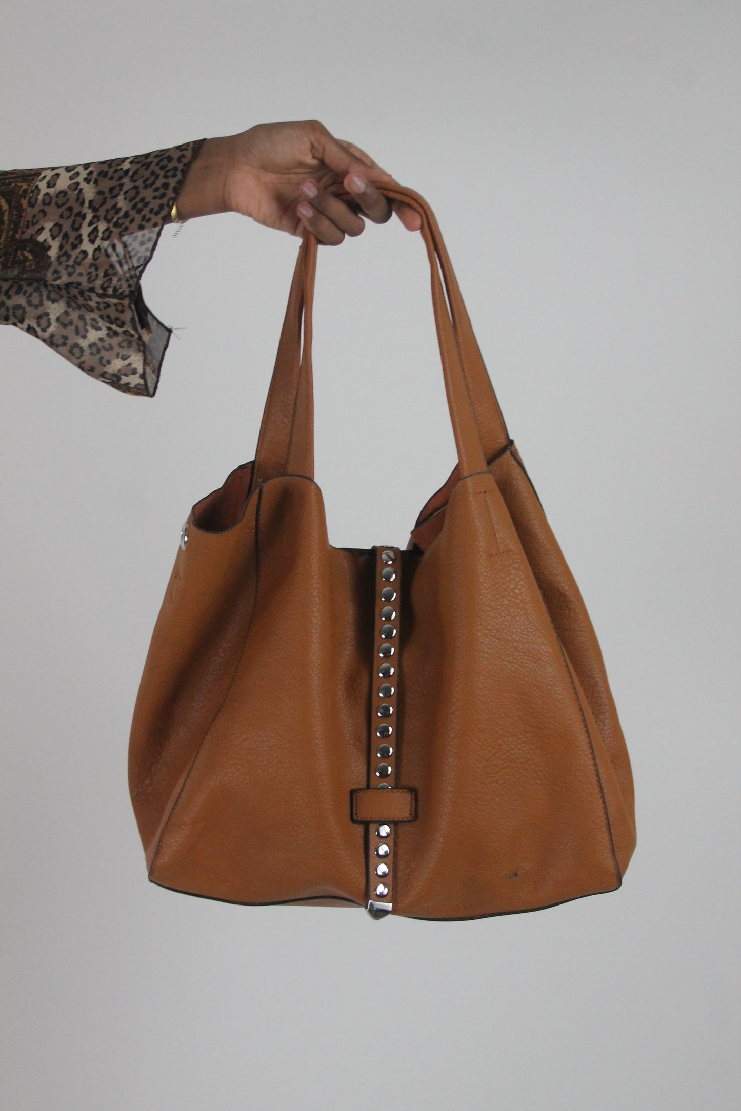 front view of tan studded large shoulder bag