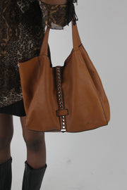 worn view of tan studded large shoulder bag