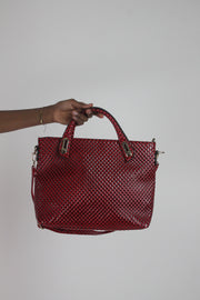 back view of red woven-effect structured handbag with shoulder strap