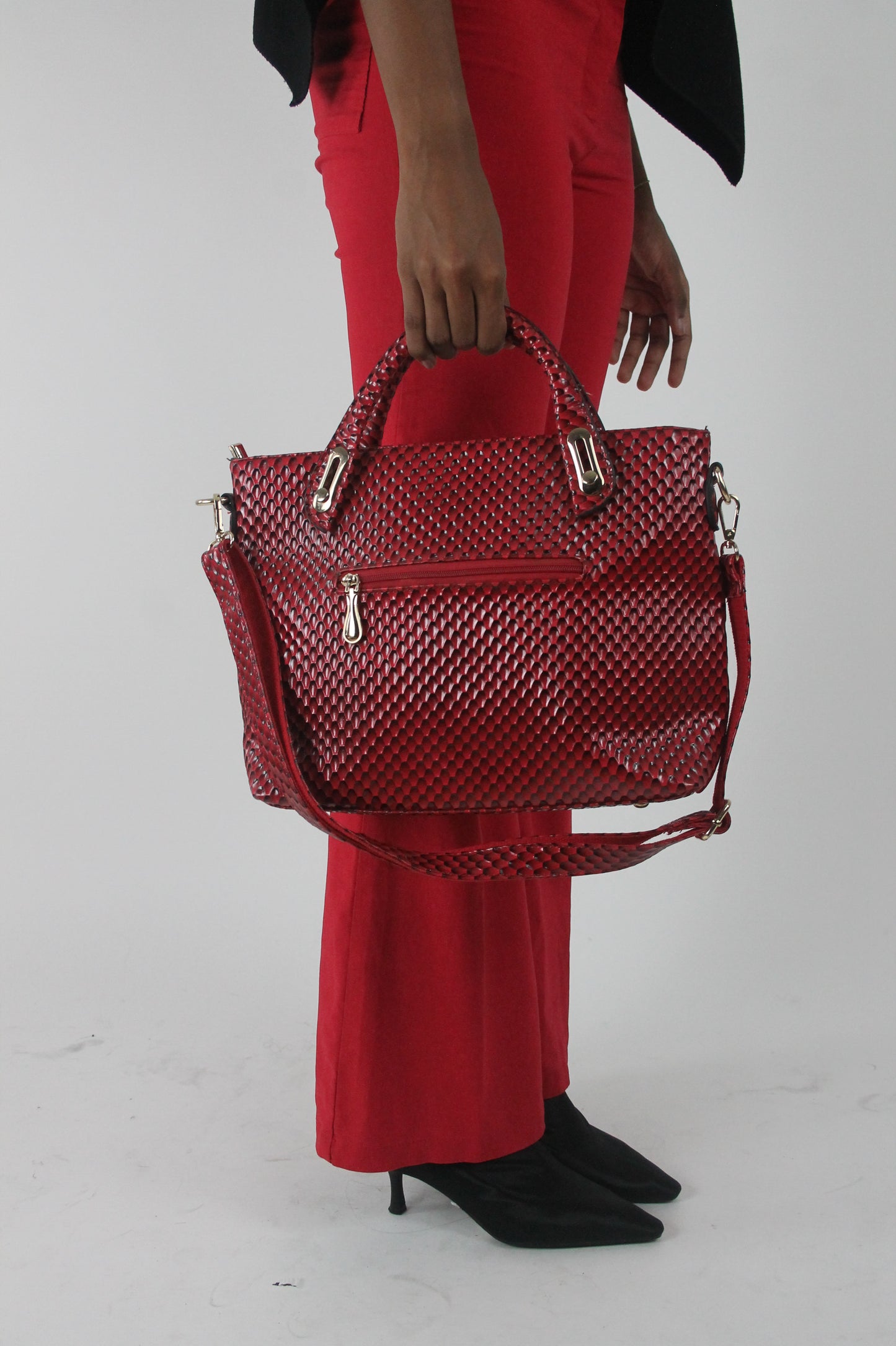 red woven-effect structured handbag carried by the top handles