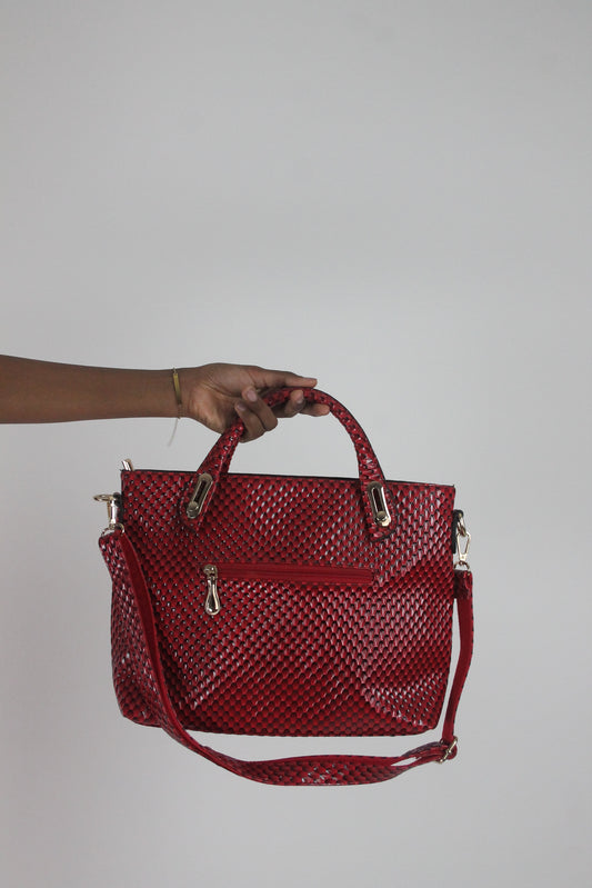 front view of red woven-effect structured handbag with shoulder strap
