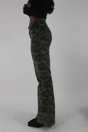 alternate-side view of black and cream zebra-print flared trousers