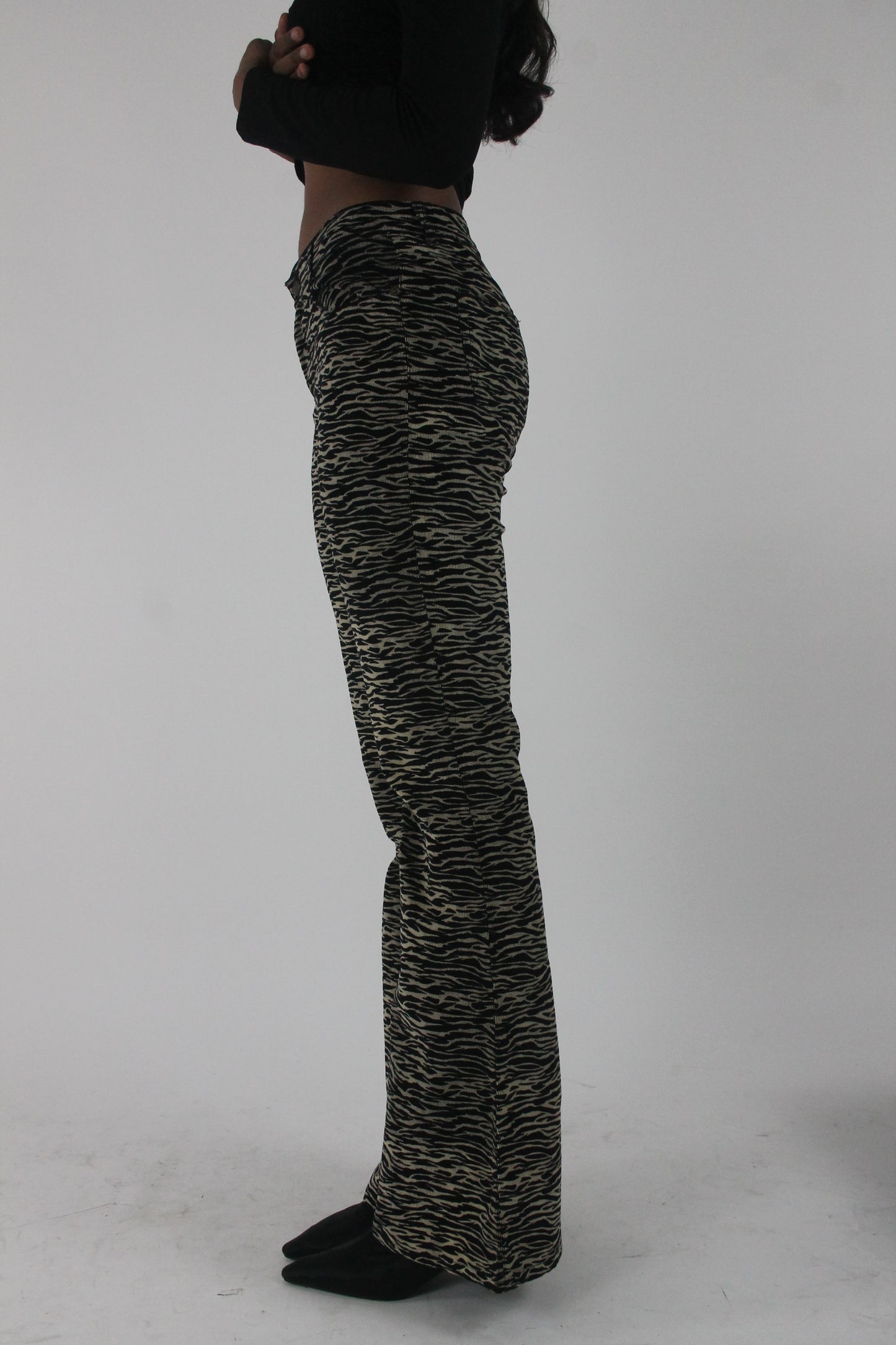 alternate-side view of black and cream zebra-print flared trousers