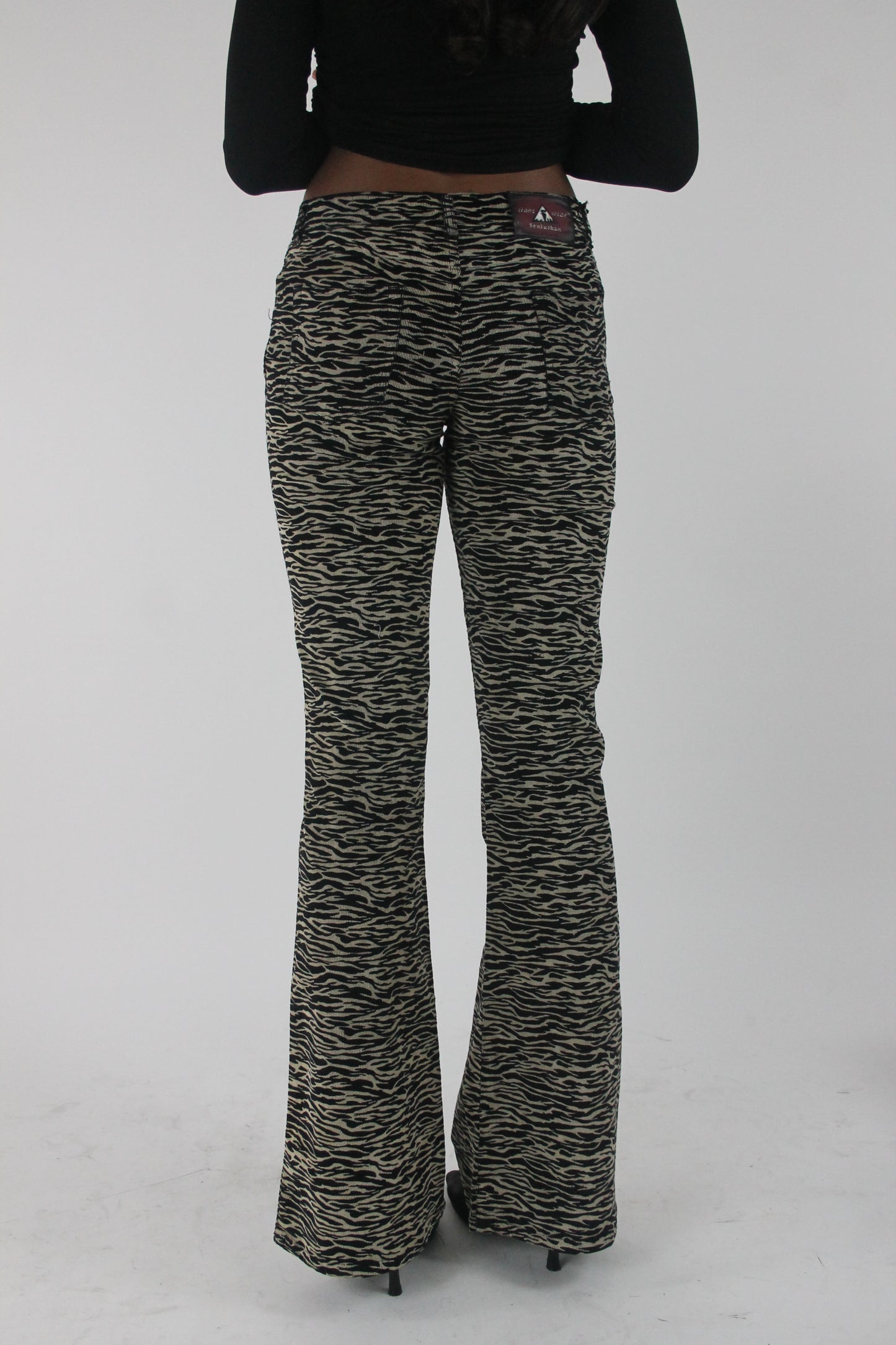 back view of black and cream zebra-print flared trousers