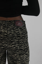 detail view of black and cream zebra-print flared trousers