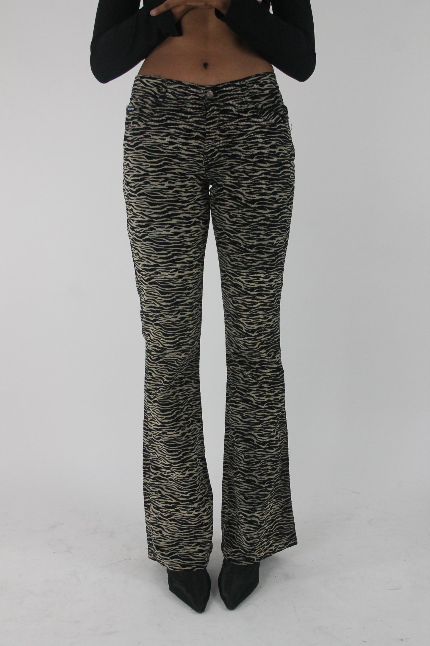 front view of black and cream zebra-print flared trousers