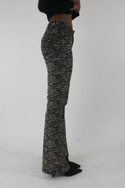 side view of black and cream zebra-print flared trousers