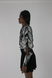 alternate-side view of black and grey abstract-striped asymmetric blouse