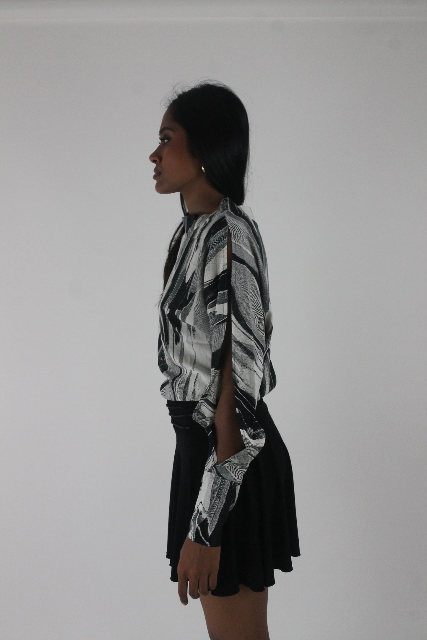 alternate-side view of black and grey abstract-striped asymmetric blouse