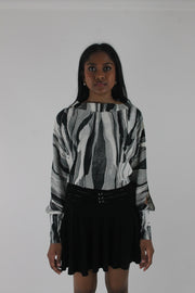 front view of black and grey abstract-striped asymmetric blouse