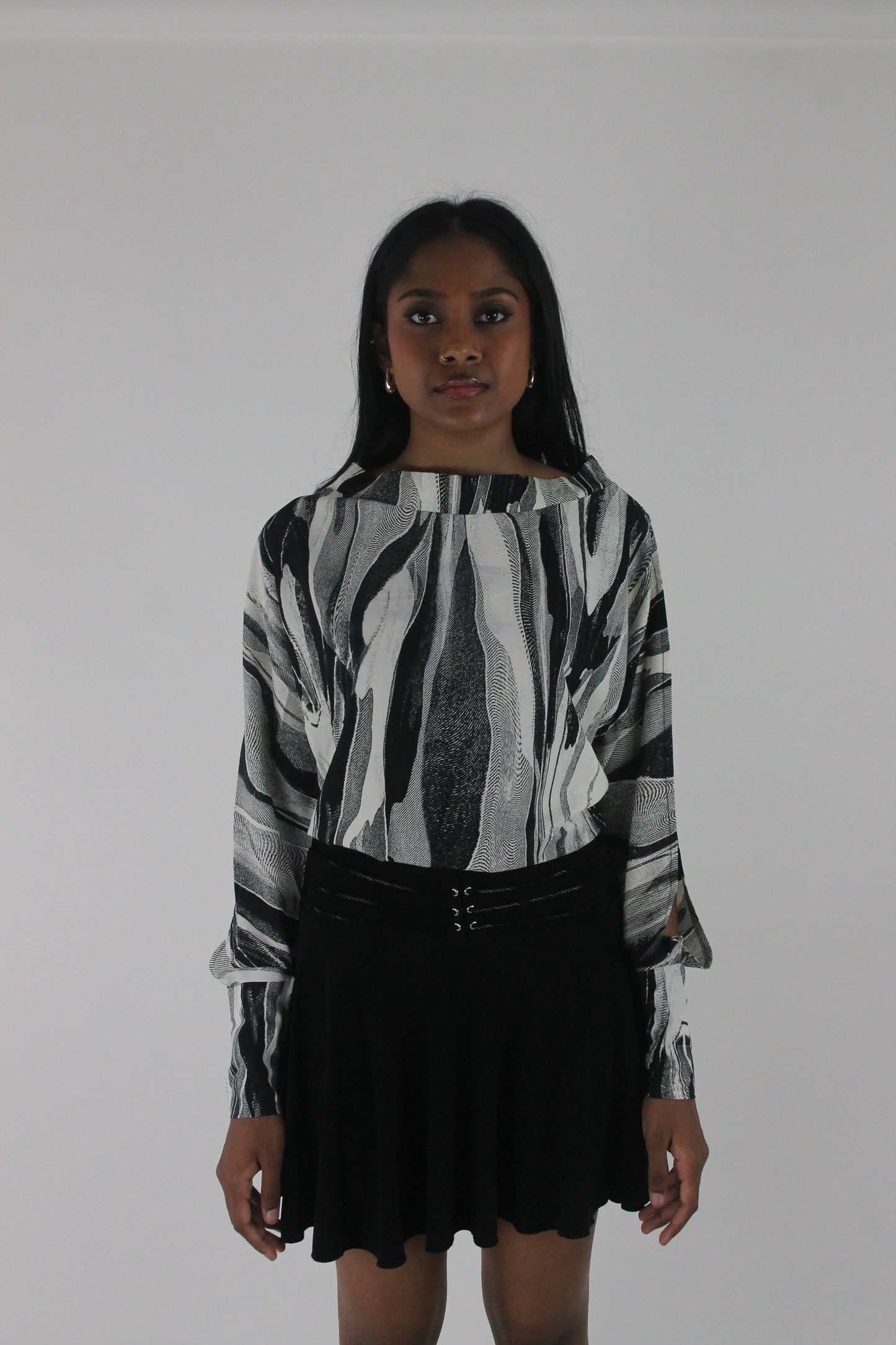 front view of black and grey abstract-striped asymmetric blouse