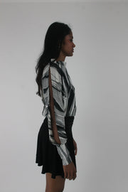 side view of black and grey abstract-striped asymmetric blouse