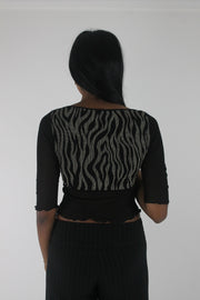 back view of black and grey zebra-pattern cropped top