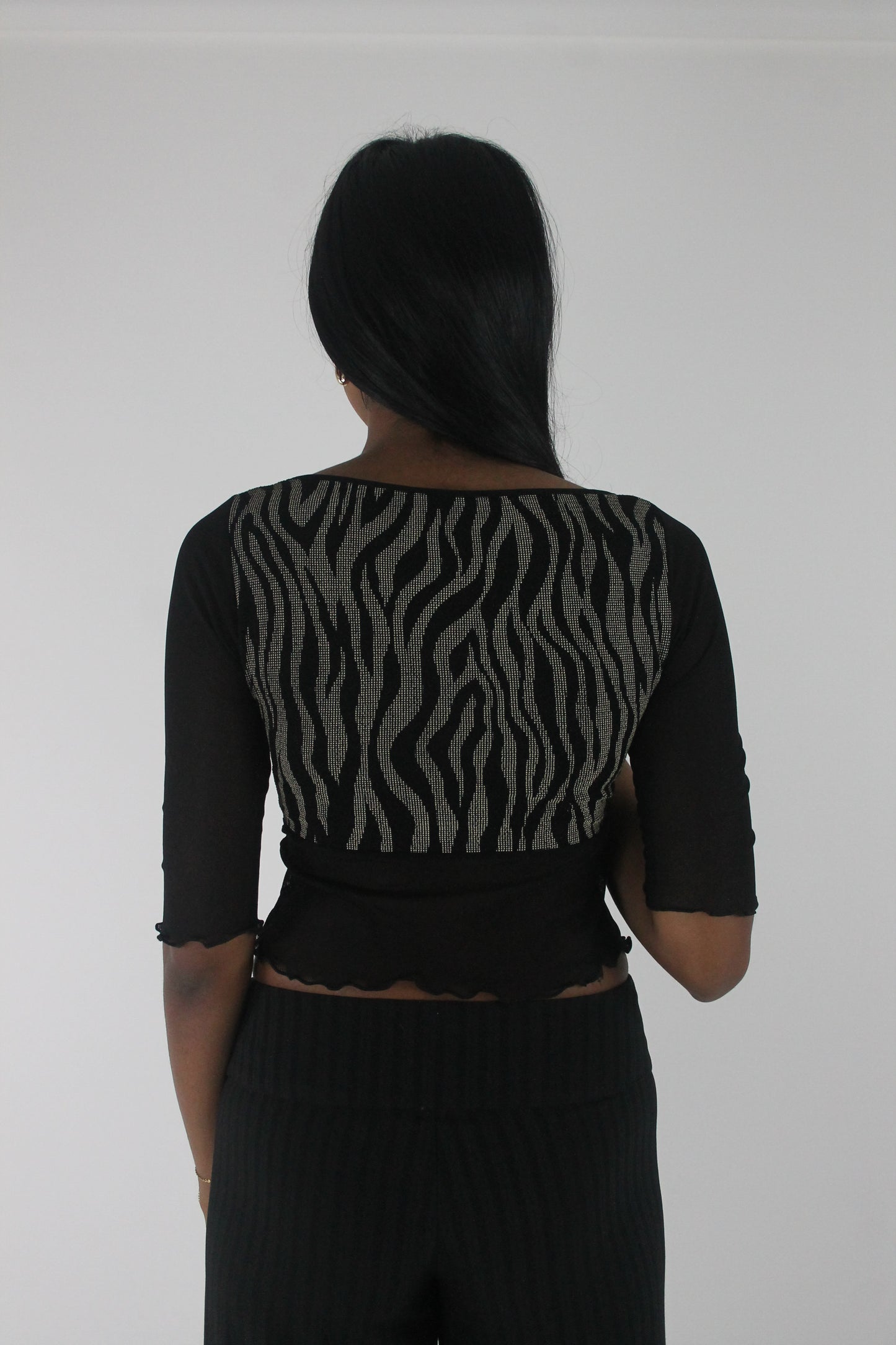 back view of black and grey zebra-pattern cropped top