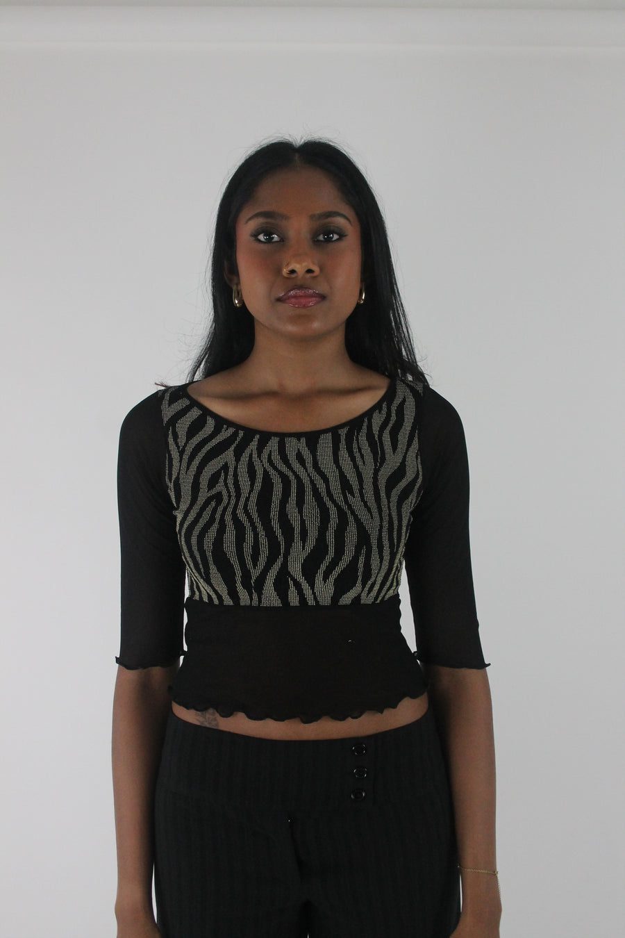 front view of black and grey zebra-pattern cropped top
