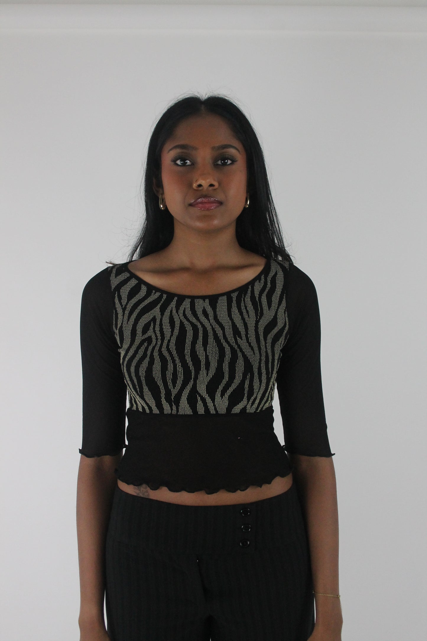 front view of black and grey zebra-pattern cropped top