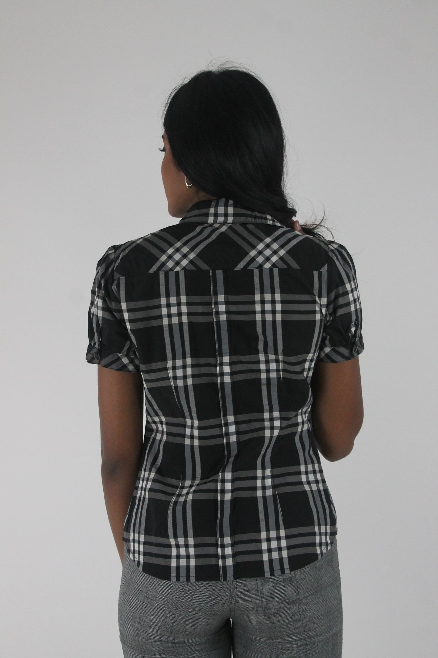 back view of black and white plaid short-sleeve fitted blazer