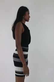 side view of black and white striped cowl-neck sleeveless mini dress