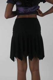 back view of black asymmetric handkerchief-hem skirt