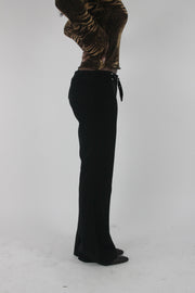 alternate-side view of black buckle-belt flared trousers
