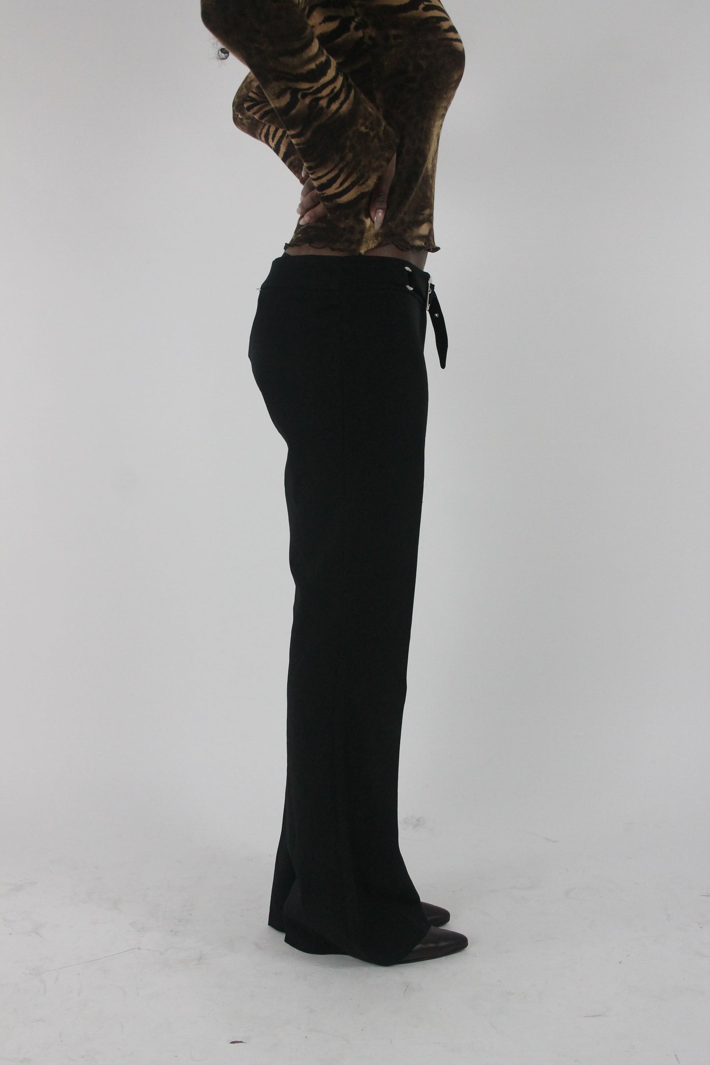 alternate-side view of black buckle-belt flared trousers