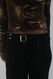 detail view of black buckle-belt flared trousers