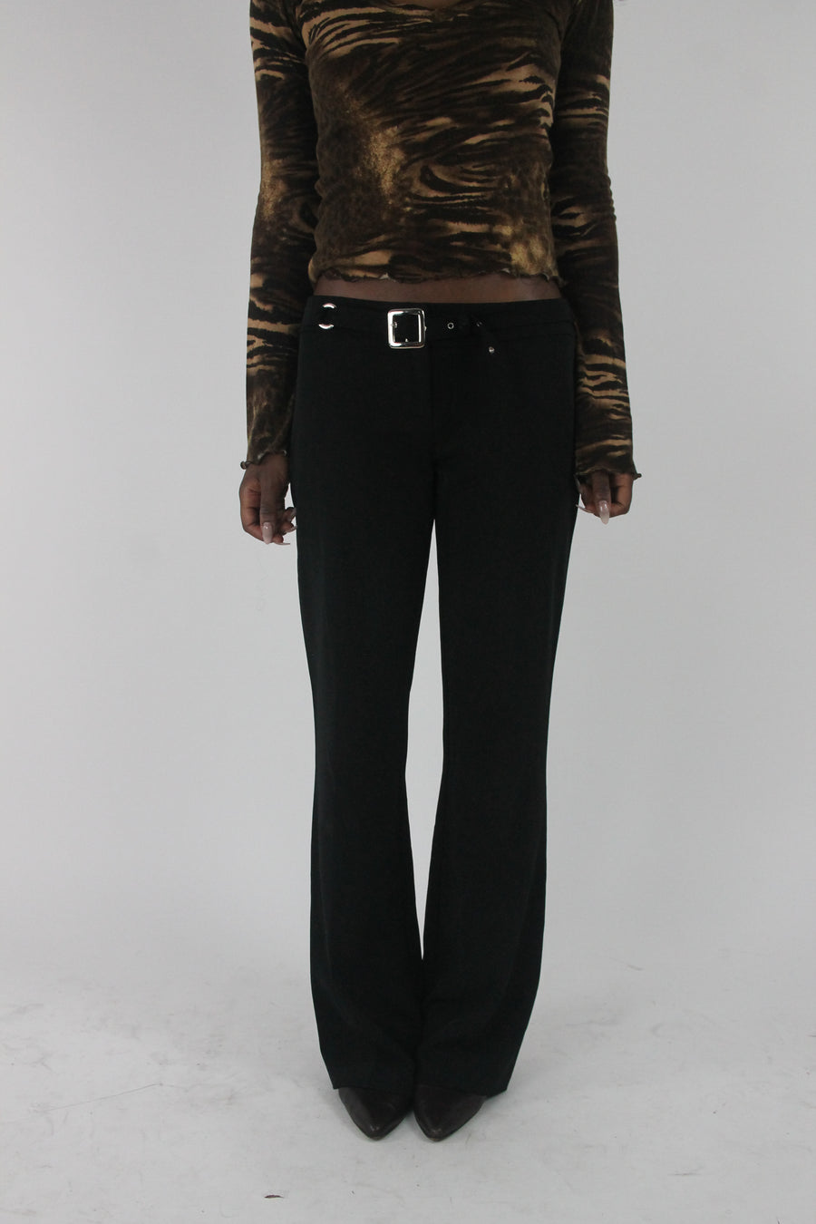 front view of black buckle-belt flared trousers