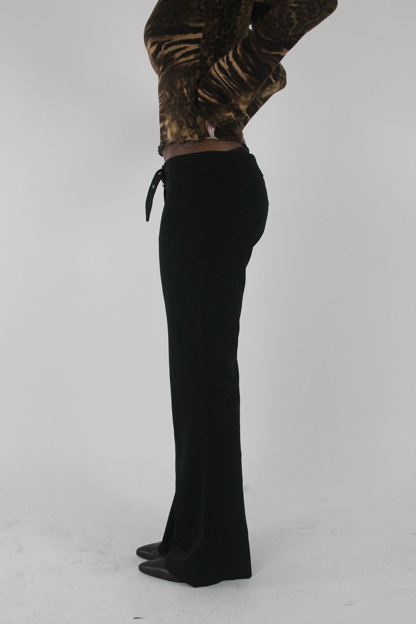side view of black buckle-belt flared trousers