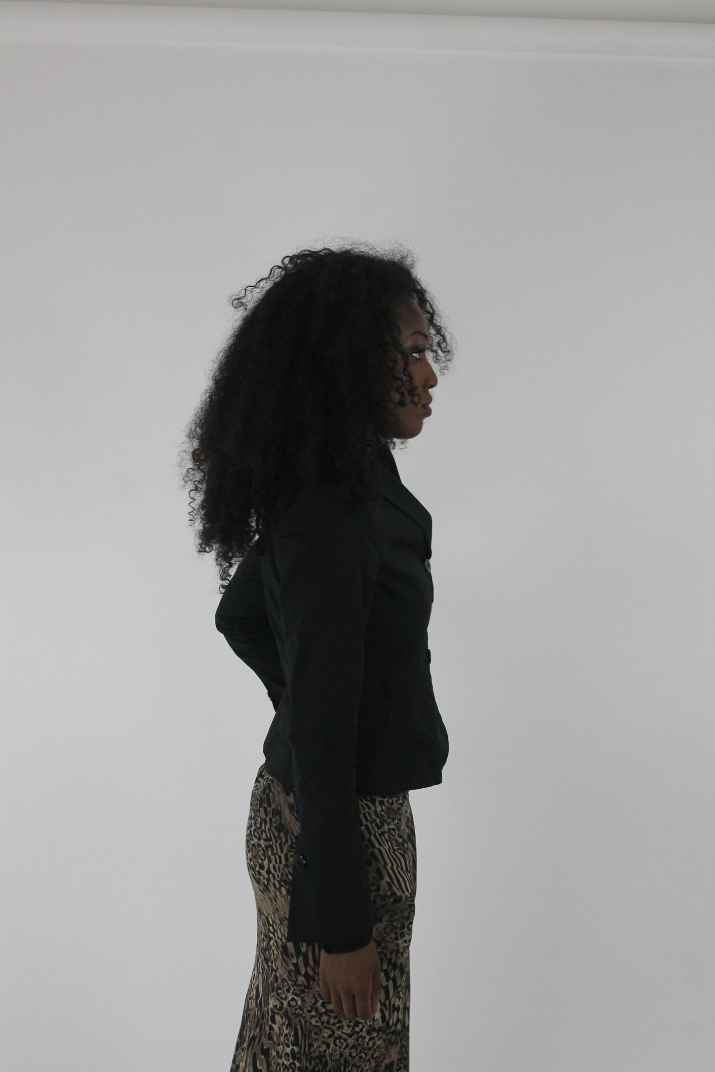alternate-side view of black cropped single-button blazer