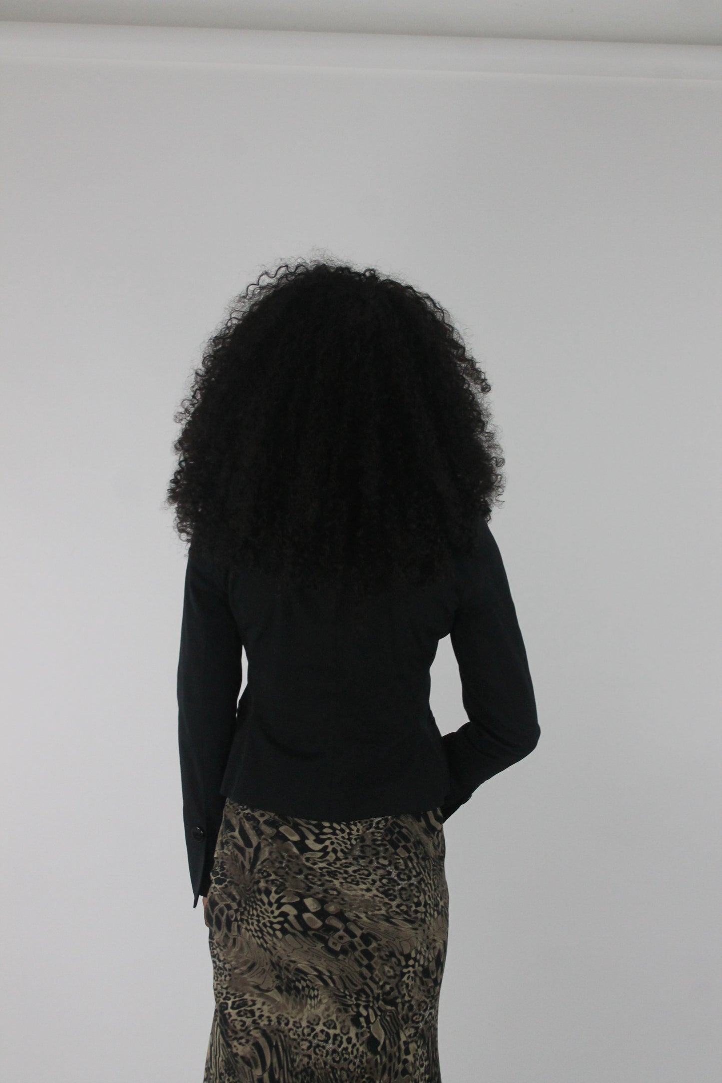 back view of black cropped single-button blazer