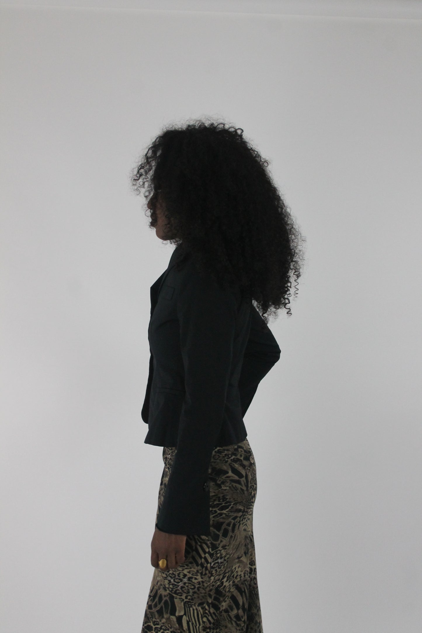 side view of black cropped single-button blazer